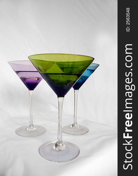 Brightly colored martini glasses on a white background. Brightly colored martini glasses on a white background