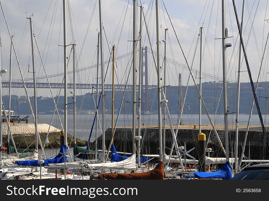 A scenic marina sits against a picturesque bridge. A scenic marina sits against a picturesque bridge