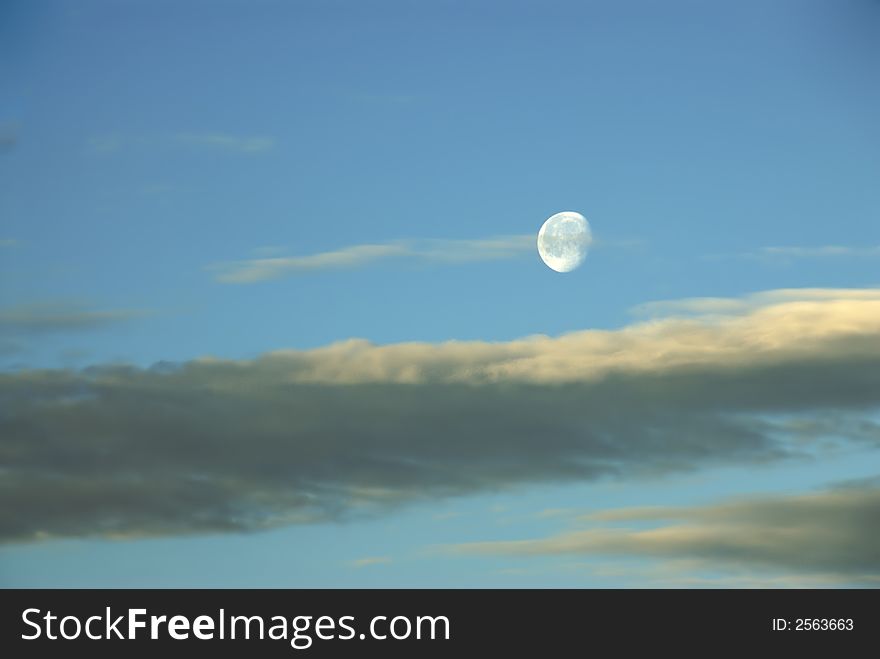 A beautiful moonrise in a cloudy twillight sky. A beautiful moonrise in a cloudy twillight sky