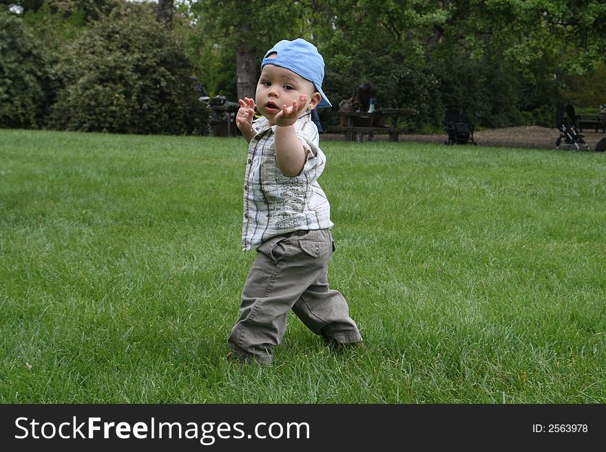 Baby, looking over his shoulder, while practicing walking. Baby, looking over his shoulder, while practicing walking