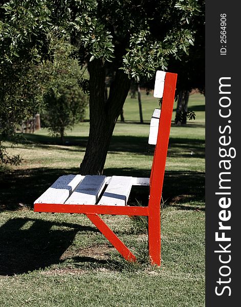 Bench with white and red in a park. Bench with white and red in a park