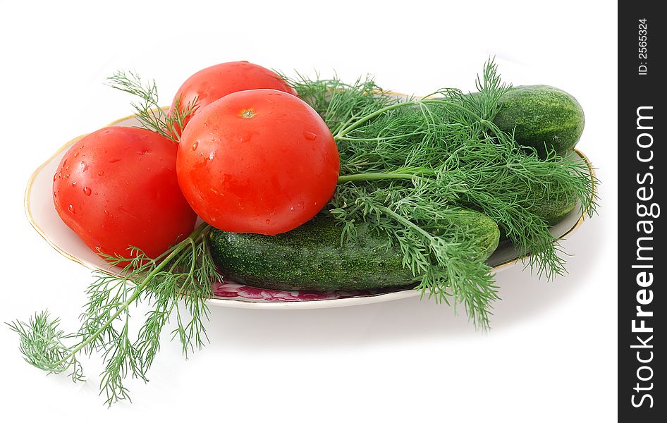 Tomatoes and cucumbers on plate isolated