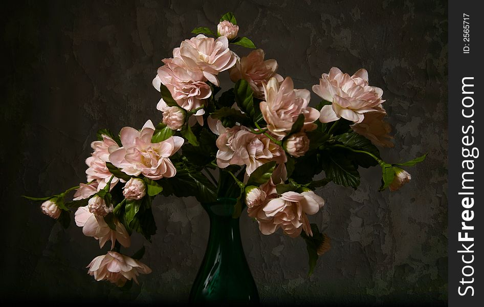 Artificial flowers on a background of an old wall