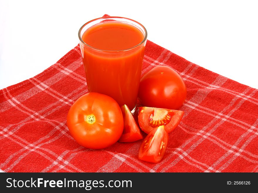 Close-up of a few tomatoes and a glass of juice. Close-up of a few tomatoes and a glass of juice.