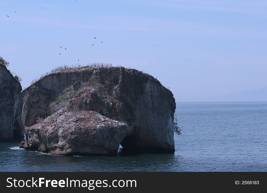 Giant rocks with arches off the coast. Giant rocks with arches off the coast
