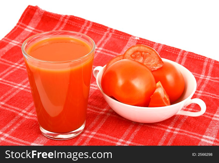 Close-up of a few tomatoes and a glass of juice. Close-up of a few tomatoes and a glass of juice.