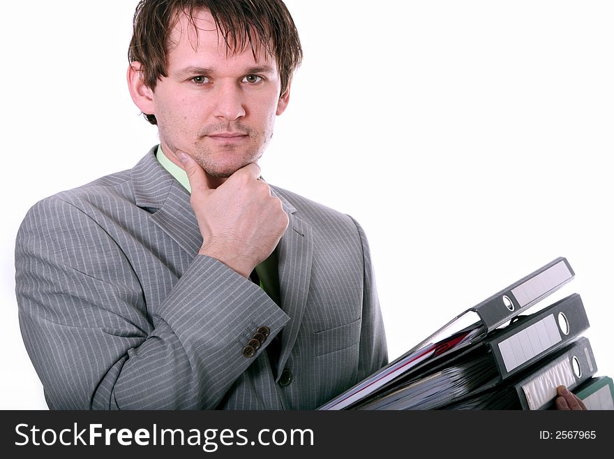 Man clothed in business suit holding many folders. Man clothed in business suit holding many folders