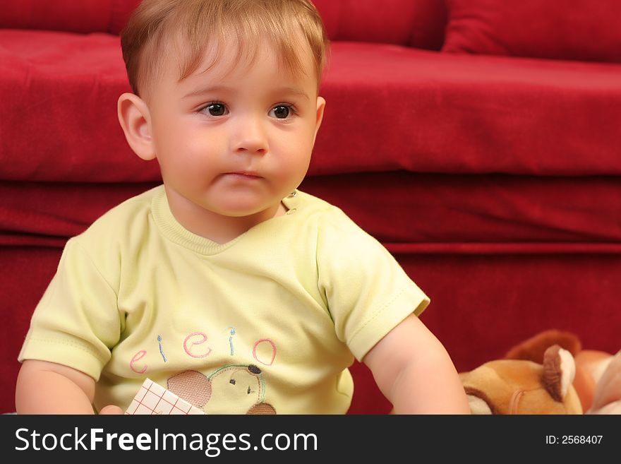 Expressive little blond baby boy gesticulate while reading a child book