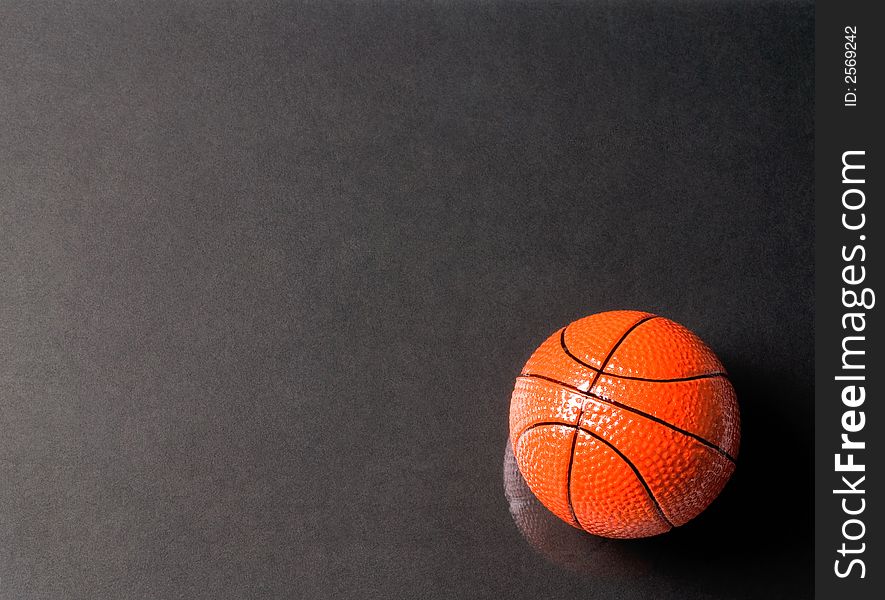 Basketball ball on glass with a black background