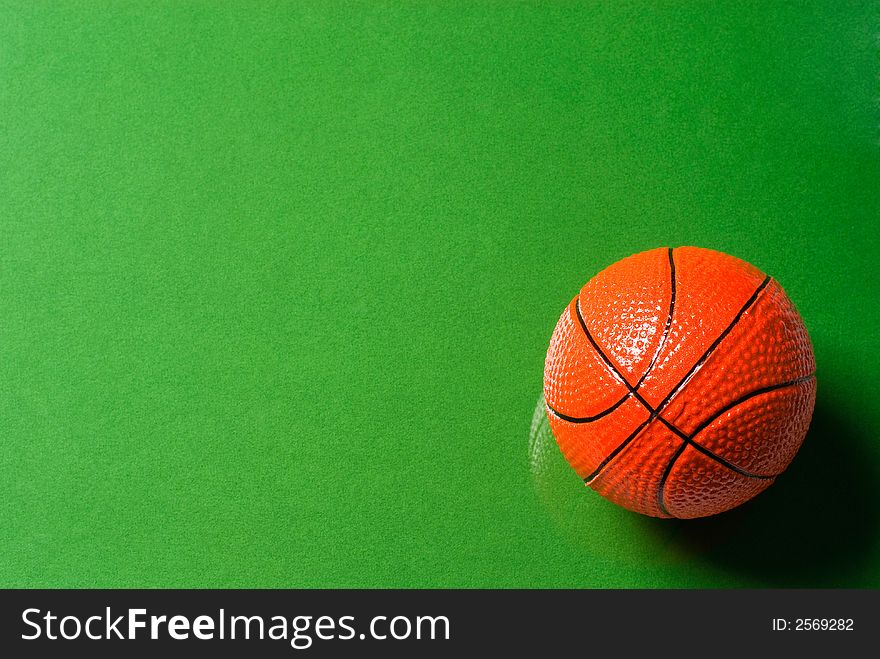 Basketball ball on glass with a green background