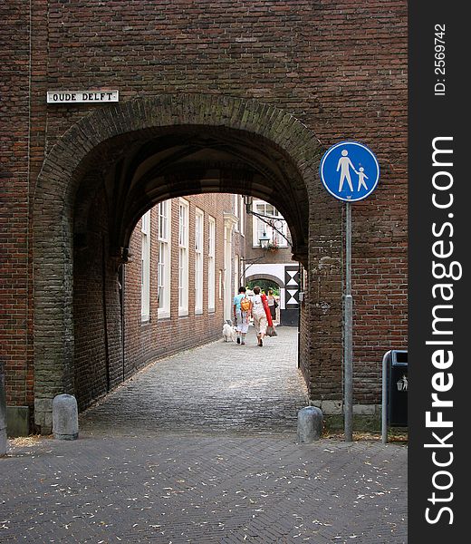 An old-fashioned passageway with an interesting signpost in the city of Delft, Netherlands. An old-fashioned passageway with an interesting signpost in the city of Delft, Netherlands.