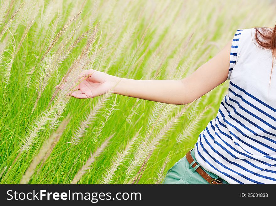 Close up of a woman's hand touching green grass. Close up of a woman's hand touching green grass