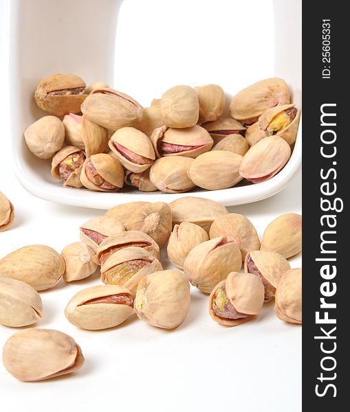 Bowl of Pistachio nuts on isolated white