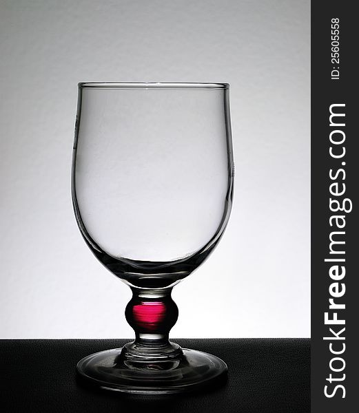 Empty glass on a white background and black base. Empty glass on a white background and black base.