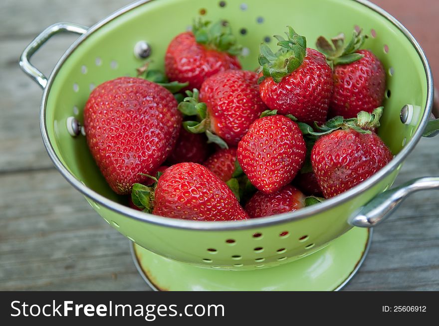 Colander full of ripe red strawberries, perfect for summer. Colander full of ripe red strawberries, perfect for summer