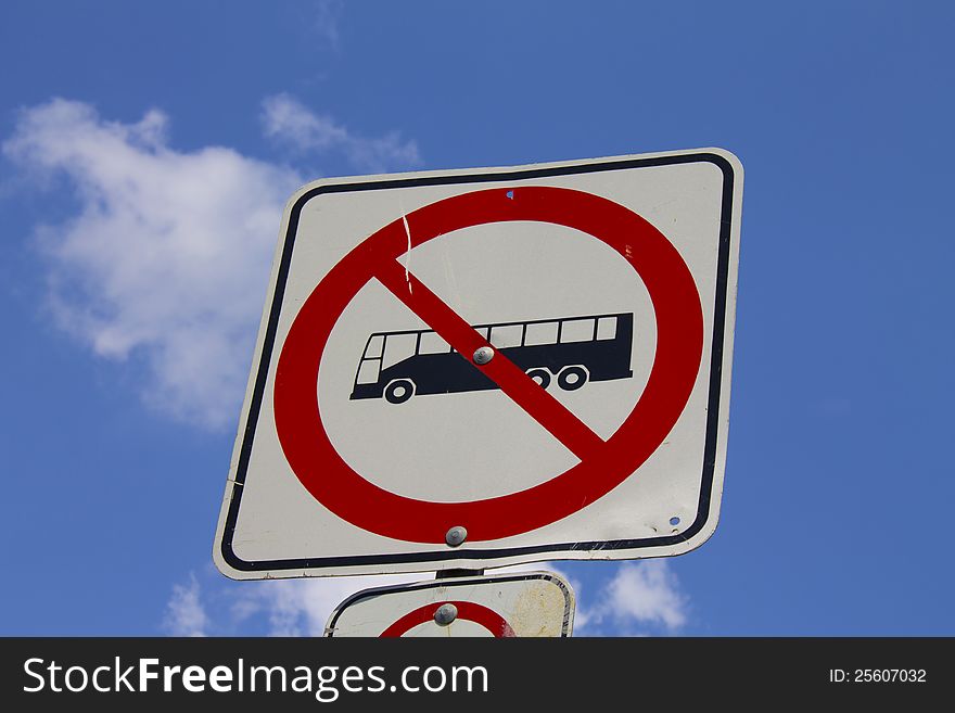 A sign to indicate that buses are not allowed on that road with the sky in the background. A sign to indicate that buses are not allowed on that road with the sky in the background