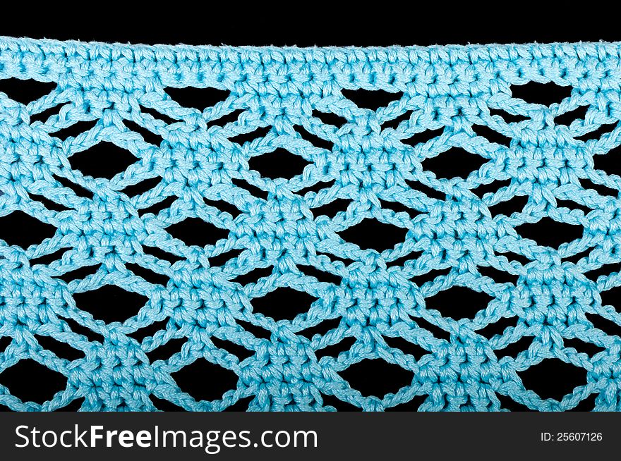 Blue knitting fabric isolated on black background