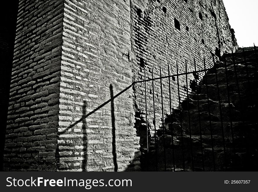 Shadow of a rail on the ancient bricks of the Colosseum.