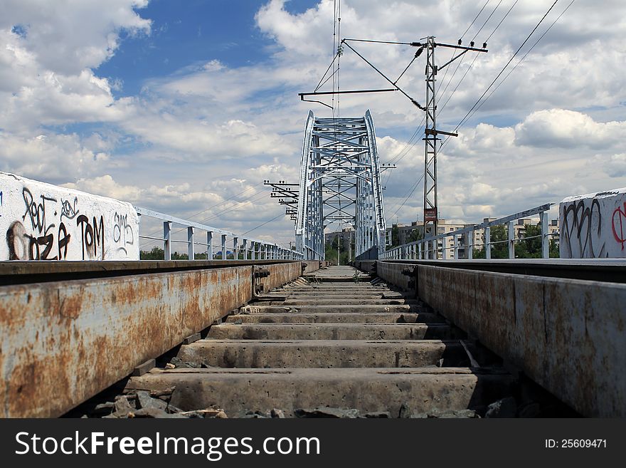 Railway bridge in Krasnoarmeysk district of Volgograd, White clouds, blue sky, fine weather