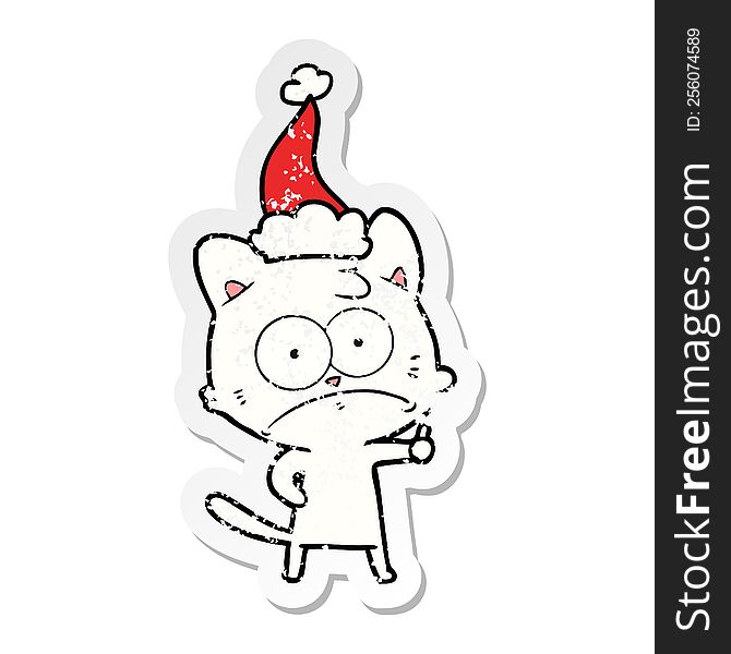Distressed Sticker Cartoon Of A Nervous Cat Wearing Santa Hat