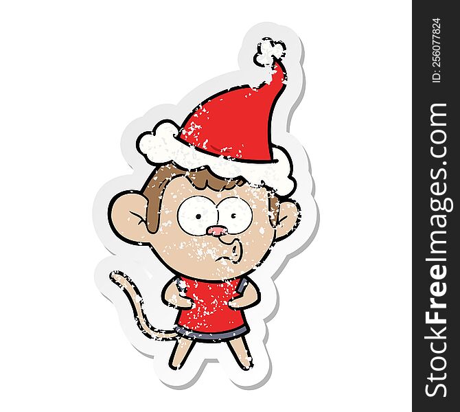 hand drawn distressed sticker cartoon of a surprised monkey wearing santa hat