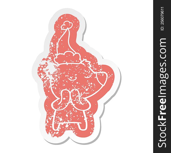 happy quirky cartoon distressed sticker of a polar bear wearing santa hat