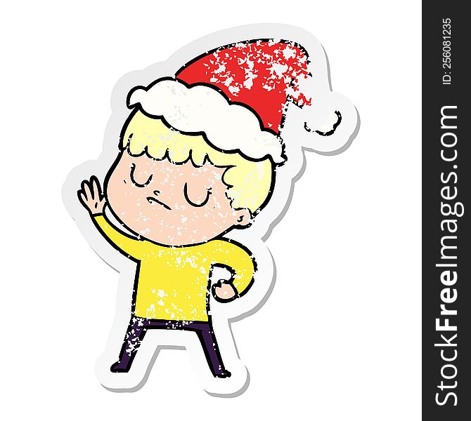 Distressed Sticker Cartoon Of A Grumpy Boy Wearing Santa Hat