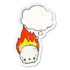 Spooky Cartoon Flaming Skull And Thought Bubble As A Distressed Worn Sticker Royalty Free Stock Photo