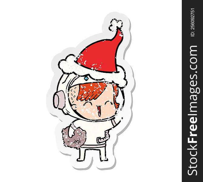 distressed sticker cartoon of a happy spacegirl holding moon rock wearing santa hat