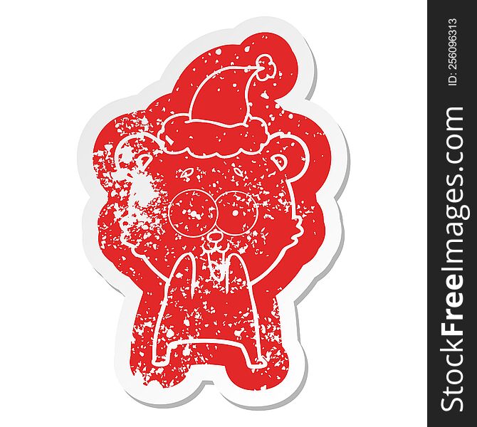 excited teddy bear quirky cartoon distressed sticker of a wearing santa hat