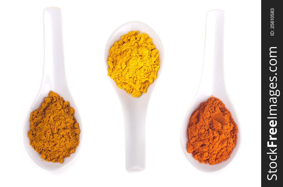 Spices in the spoons on a white background