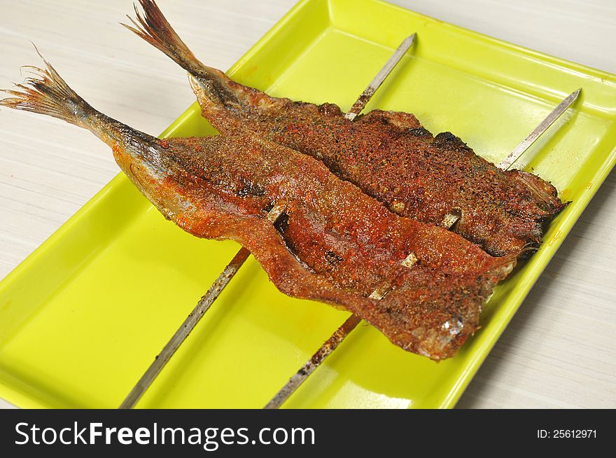 Barbecue; grilled fish on a plate