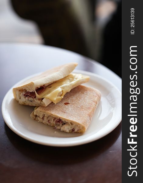 Two ham and cheese sandwiches on a plate