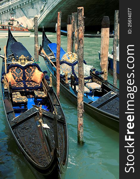 Two elegant gondolas at the pier in Venice. Two elegant gondolas at the pier in Venice.