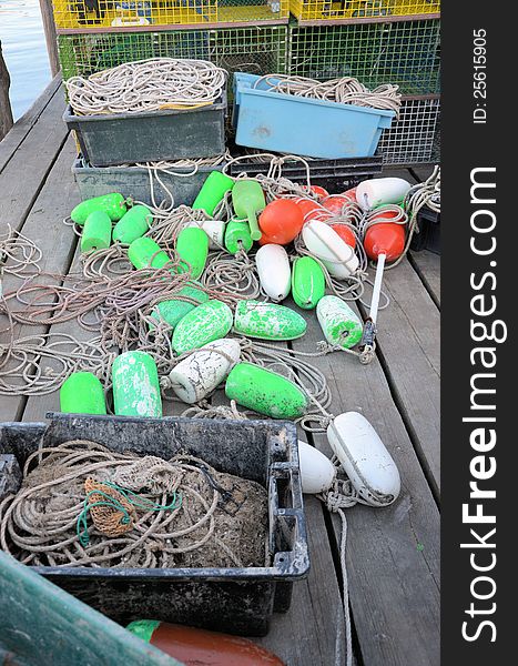 Green and white lobster bouys on the dock.