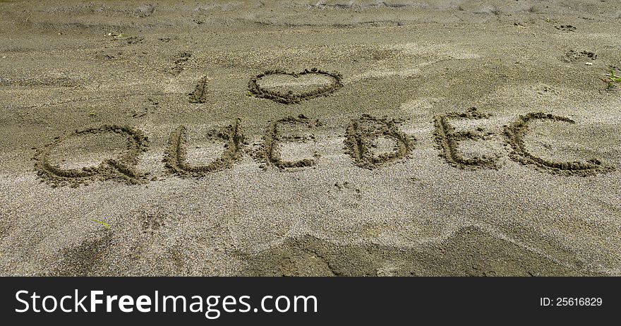 I love quebec written in the sand by the lake