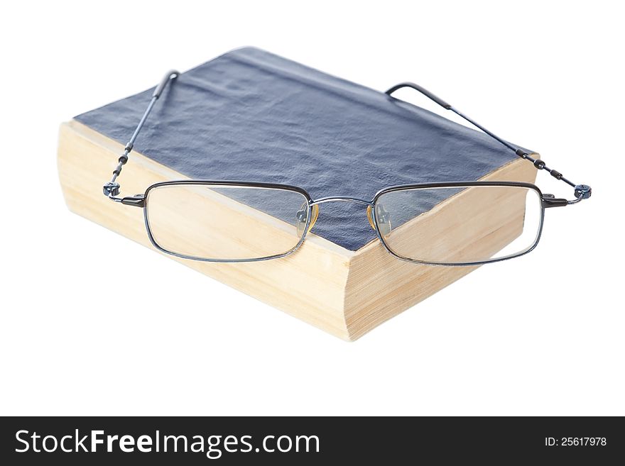 Glasses on the ancient book. On a white background.