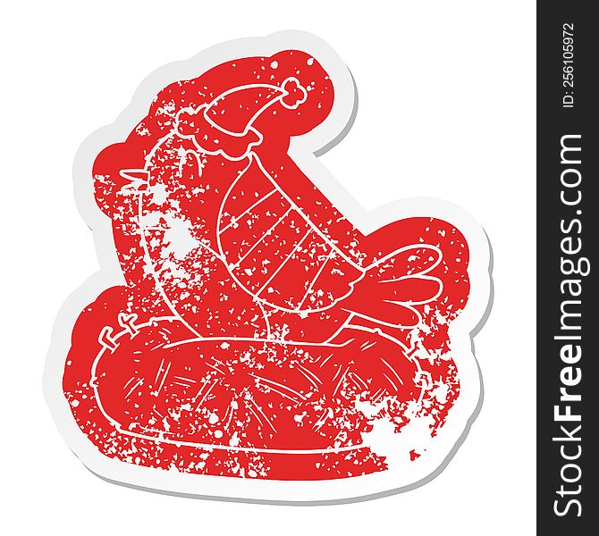 quirky cartoon distressed sticker of a bird sitting on nest wearing santa hat