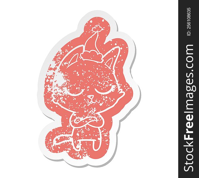 Calm Cartoon Distressed Sticker Of A Cat Wearing Santa Hat