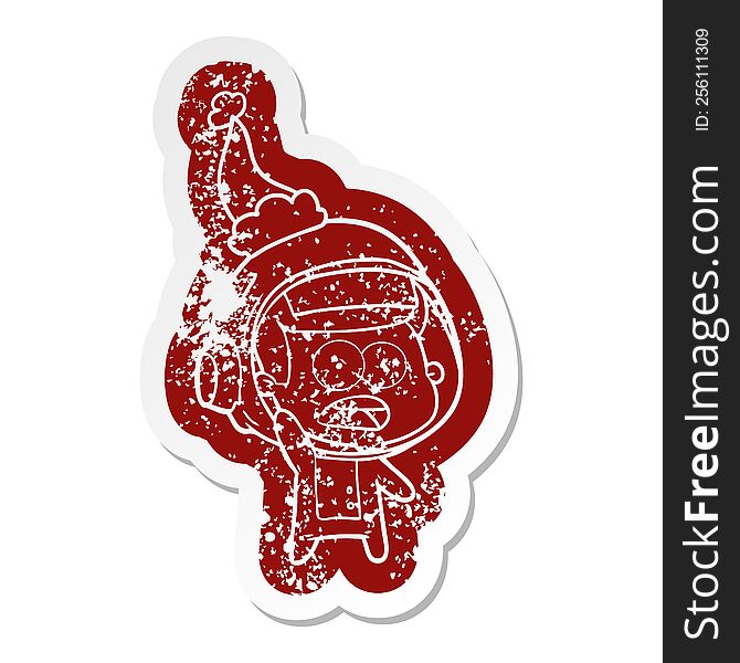 Cartoon Distressed Sticker Of A Surprised Astronaut Wearing Santa Hat
