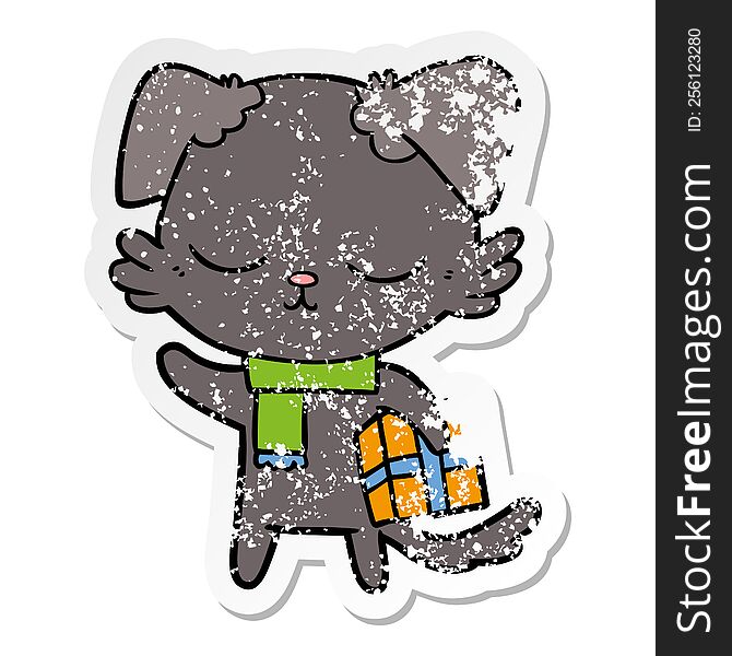 distressed sticker of a cute cartoon dog with christmas present