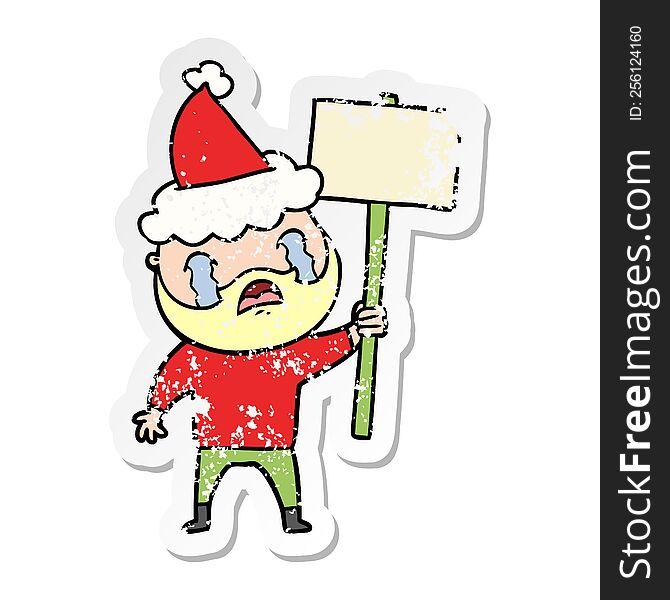 hand drawn distressed sticker cartoon of a bearded protester crying wearing santa hat