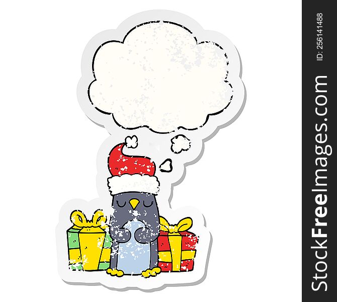 cute christmas penguin with thought bubble as a distressed worn sticker