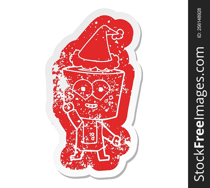 happy quirky cartoon distressed sticker of a robot waving hello wearing santa hat