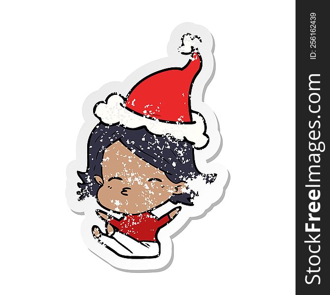 Distressed Sticker Cartoon Of A Woman Sitting Wearing Santa Hat