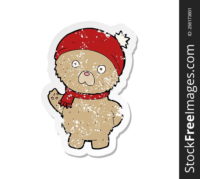 retro distressed sticker of a cartoon teddy bear in winter hat and scarf