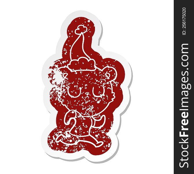 peaceful quirky cartoon distressed sticker of a bear running wearing santa hat