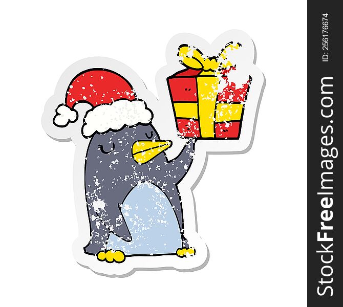 Distressed Sticker Of A Cartoon Penguin With Christmas Present