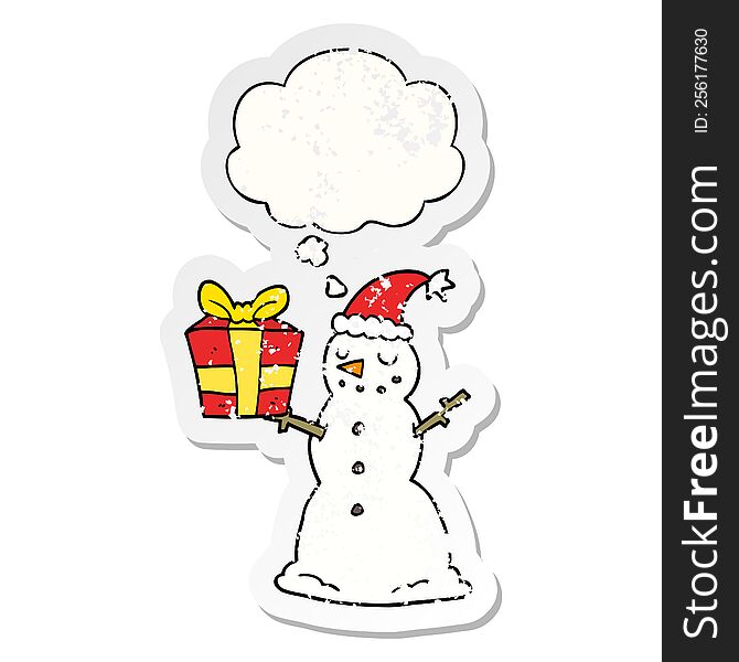 Cartoon Snowman With Present And Thought Bubble As A Distressed Worn Sticker