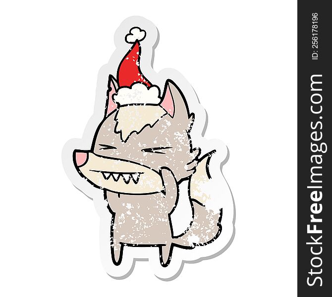 Angry Wolf Distressed Sticker Cartoon Of A Wearing Santa Hat